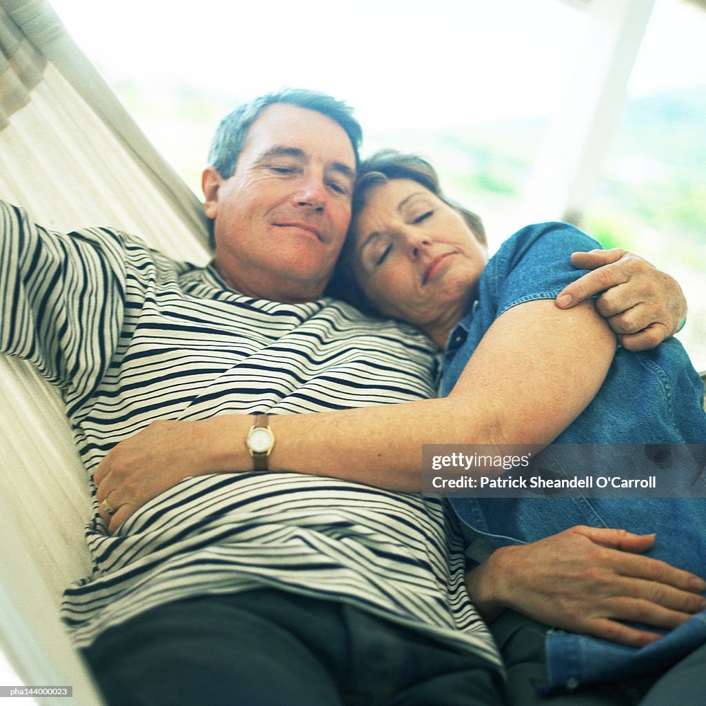 Mature couple hugging in hammock