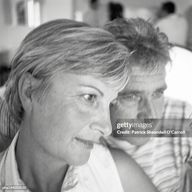 mature man and woman side by side, b&w - being watched stockfoto's en -beelden