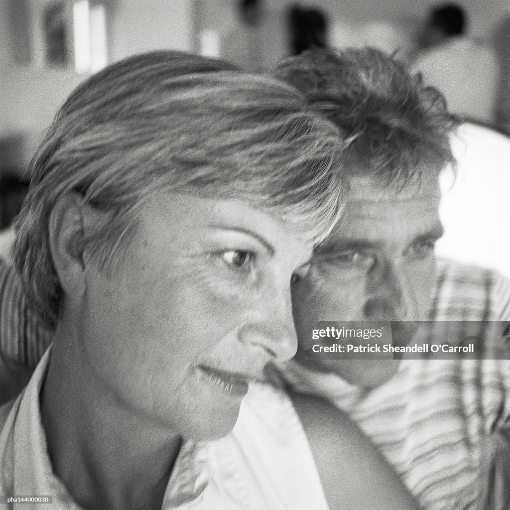 Mature man and woman side by side, b&w