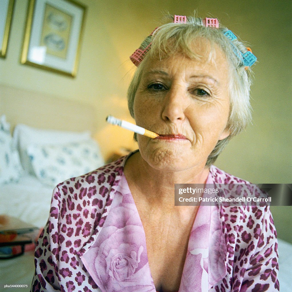 Mature woman smoking cigarette, portrait