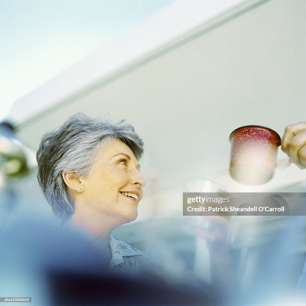 Mature woman smiling, low angle view