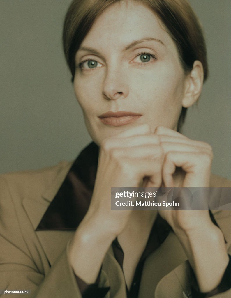 Businesswoman with hands together, portrait