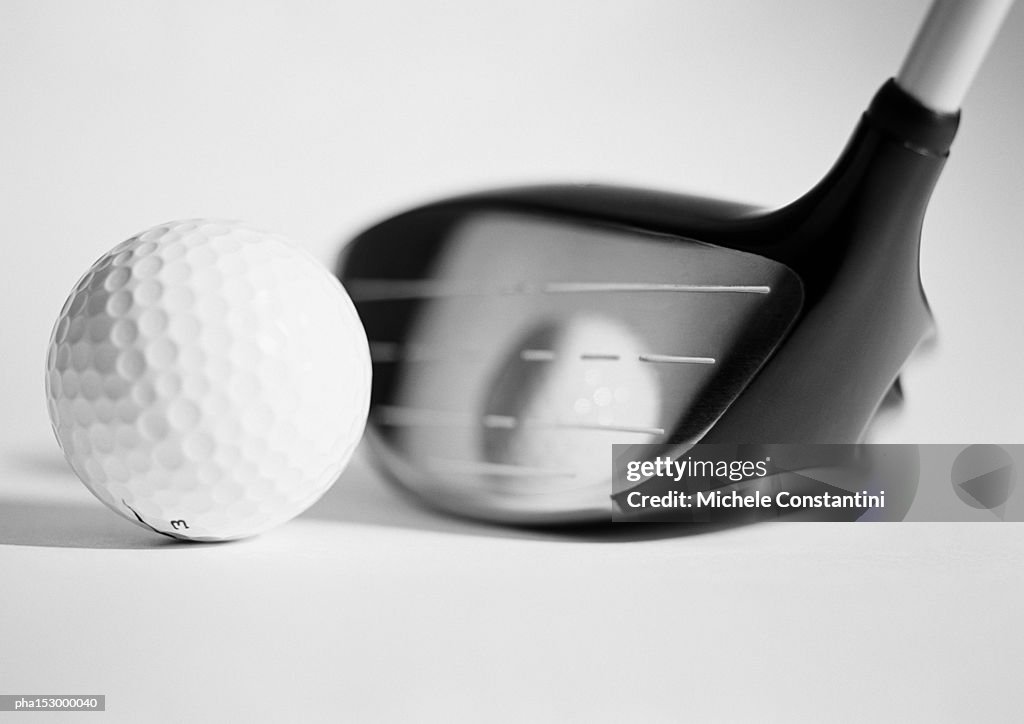 Golf club and ball, close-up, b&w.