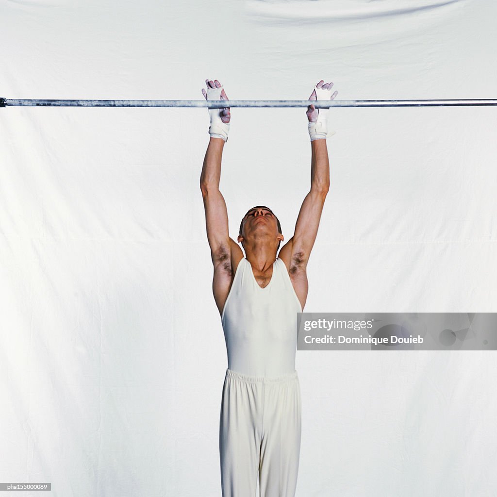 Male gymnast on horizontal bar.