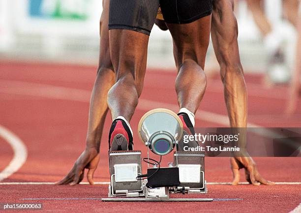 male runner on starting block, rear view - spikskor för löpning bildbanksfoton och bilder