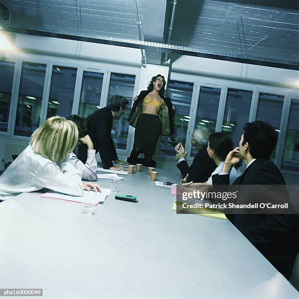 young woman office worker standing on chair, stripping, colleagues watching. - nosy woman bildbanksfoton och bilder