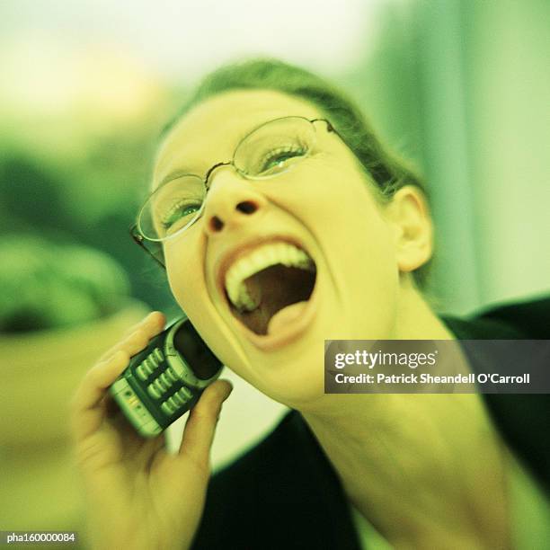 woman laughing, using cell phone, portrait. - o foto e immagini stock