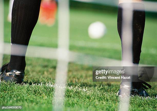 goal keeper in front of goal area, low section, blurred. - punishment stock pictures, royalty-free photos & images