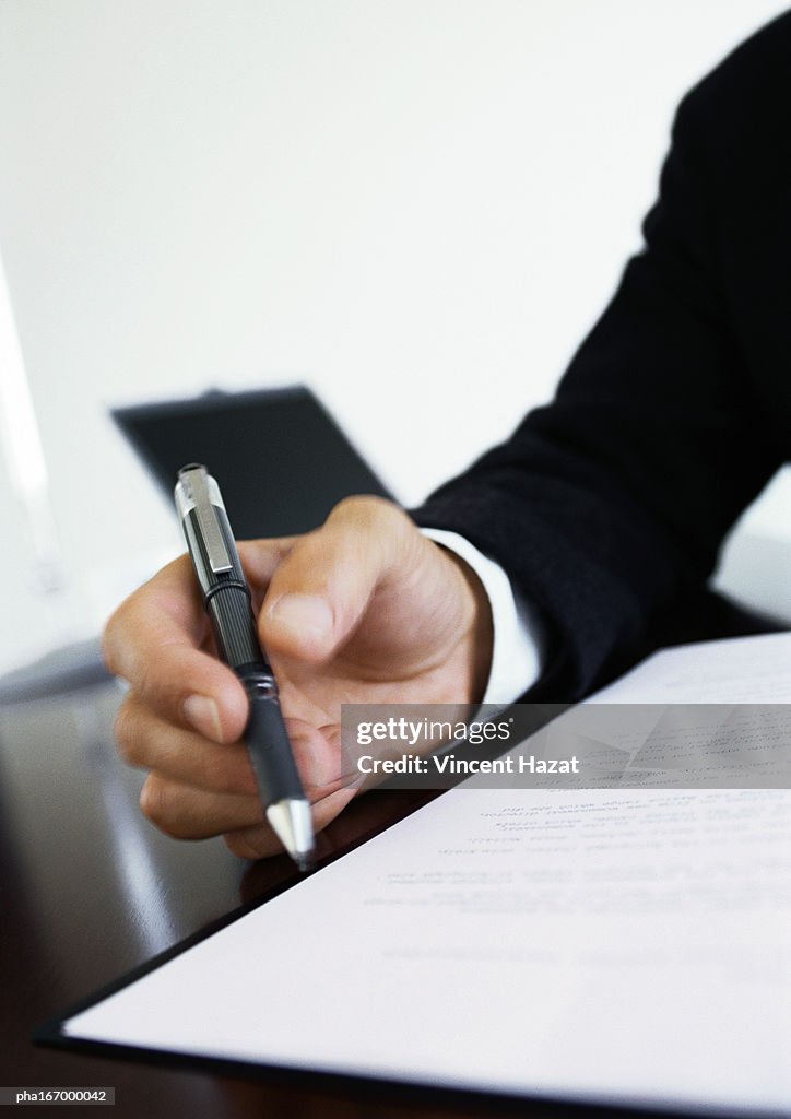 Hand holding pen, close-up