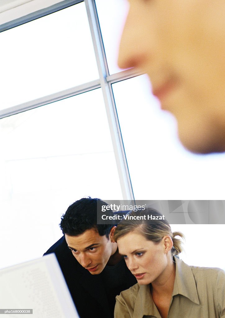 Man and woman in front of glass wall, close-up