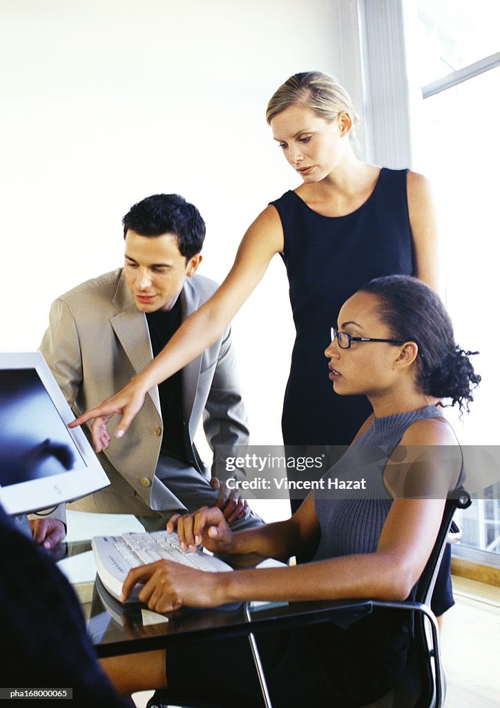 Business people looking at computer screen