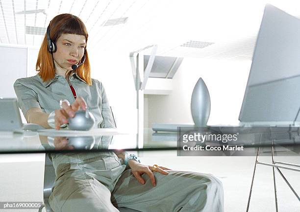woman sitting at desk, three quarter length - three quarter length stock-fotos und bilder