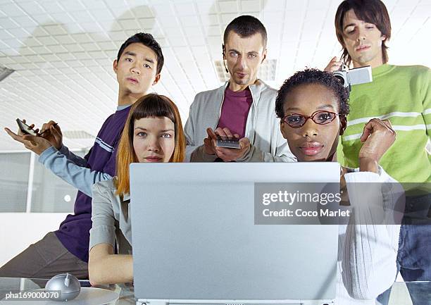 small group of young people, in focus, behind computer screen in foreground - africain stockfoto's en -beelden