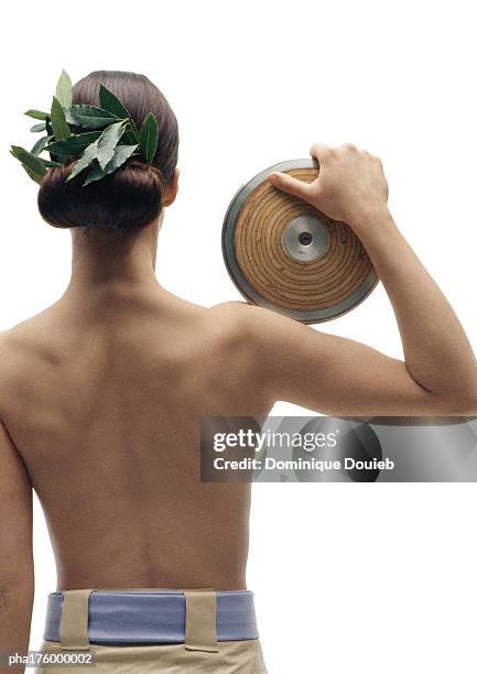 half-nude woman holding discus on shoulder, rear view - womens field event stock pictures, royalty-free photos & images