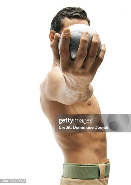 half-nude man holding shot put - men's field event stock pictures, royalty-free photos & images