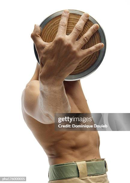 half-nude man holding discus - men's field event stockfoto's en -beelden