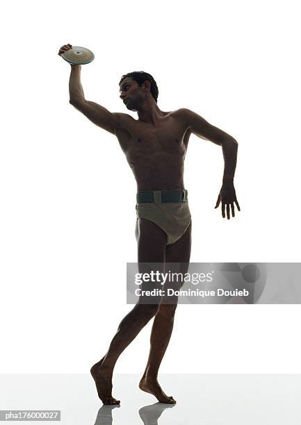 half-nude man holding discus - mens field event stockfoto's en -beelden