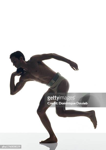 half-nude man preparing to throw the shot put - men's field event stockfoto's en -beelden