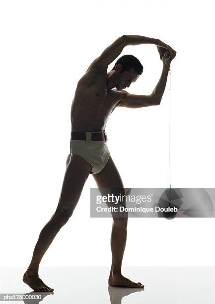 half-nude male hammer thrower, side view - men's field event stockfoto's en -beelden
