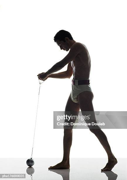 half-nude male hammer thrower, side view - mens field event stockfoto's en -beelden