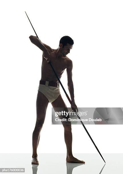 half-nude male javelin thrower - men's field event stockfoto's en -beelden