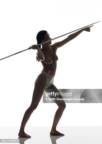 half-nude woman preparing to throw javelin, side view - womens field event bildbanksfoton och bilder