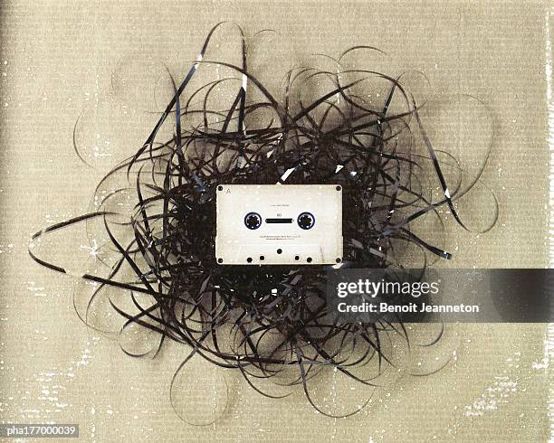 cassette on pile of entangled tape - cassette audio stock pictures, royalty-free photos & images