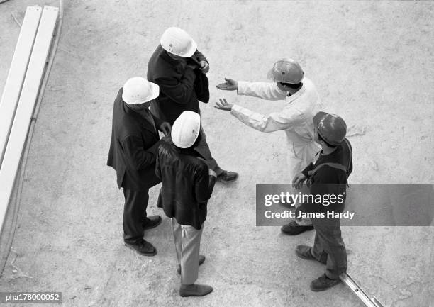 five people wearing hard hats, elevated view, full length - persuasion stock pictures, royalty-free photos & images