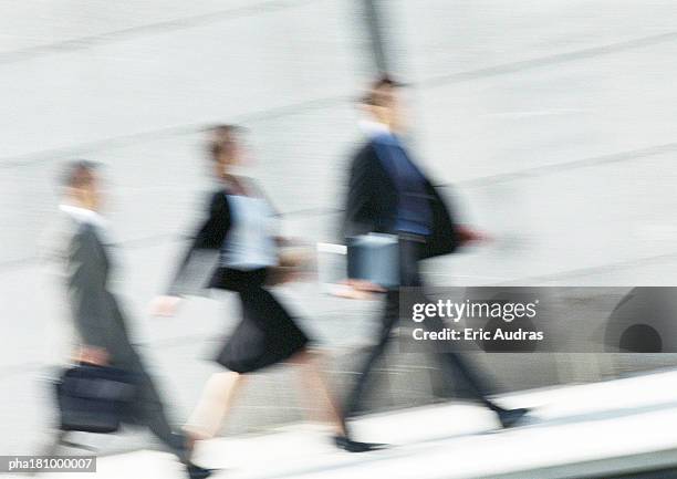 business people walking in street, full length, tilt, blurred - full time employment stock pictures, royalty-free photos & images