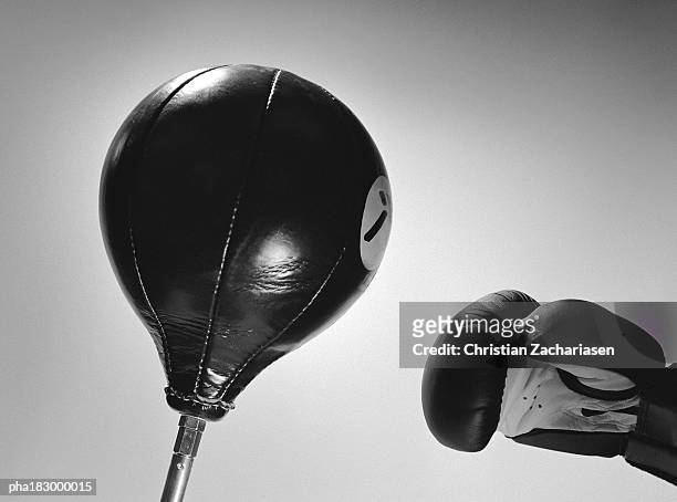 boxing glove and punch ball, close-up, b&w - punching ball stock pictures, royalty-free photos & images