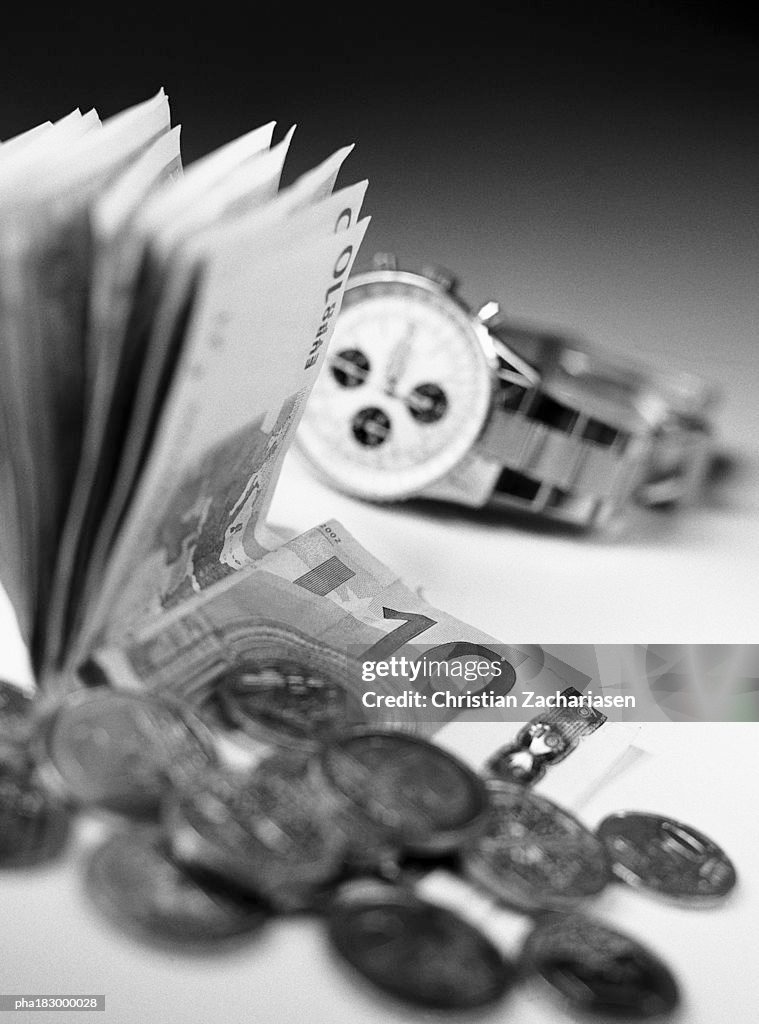 Money and watch, close-up, b&w