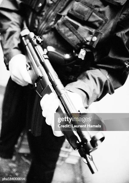 man holding sub-machine gun, close-up, b&w - criminal offense stock pictures, royalty-free photos & images