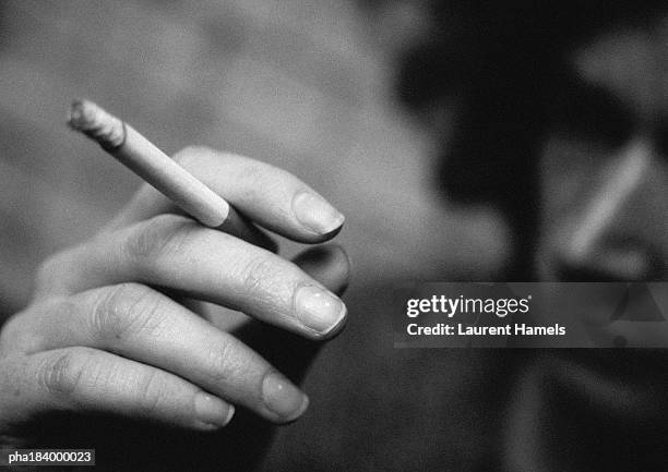 hand holding cigarette, close-up, blurred, b&w - piper perabo or maria sharapova or nastia liukin or daniella monet or erin sanders or ash stock pictures, royalty-free photos & images