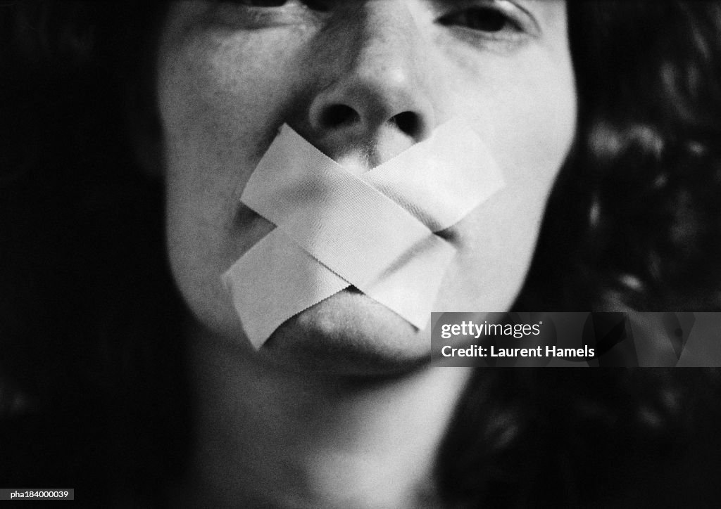 Gagged woman, close-up, blurred