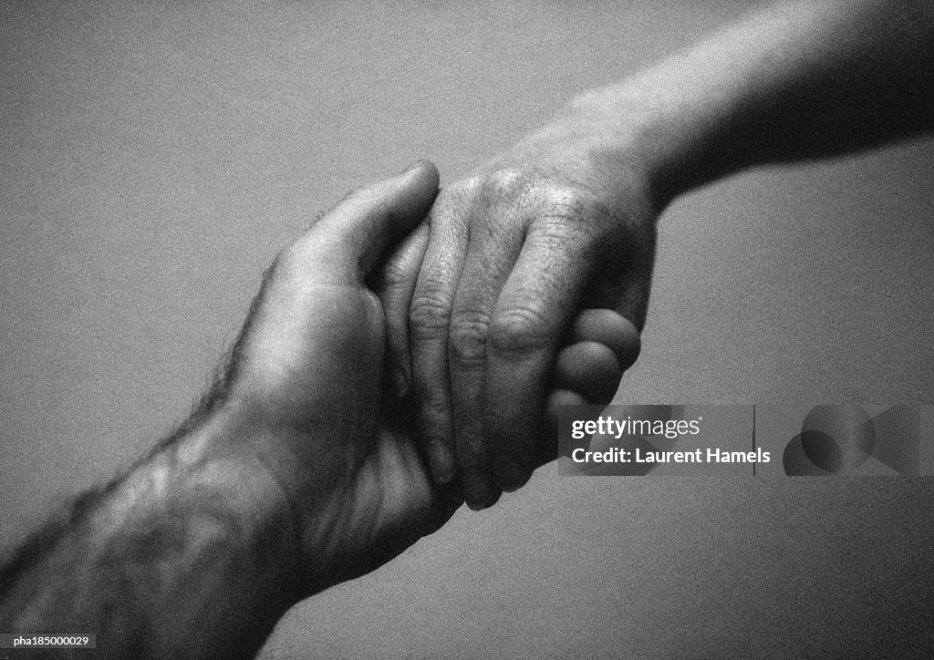 Hands clasping, close-up, b&w