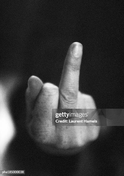 hand making obscene gesture, close-up, b&w - w hand sign stock pictures, royalty-free photos & images