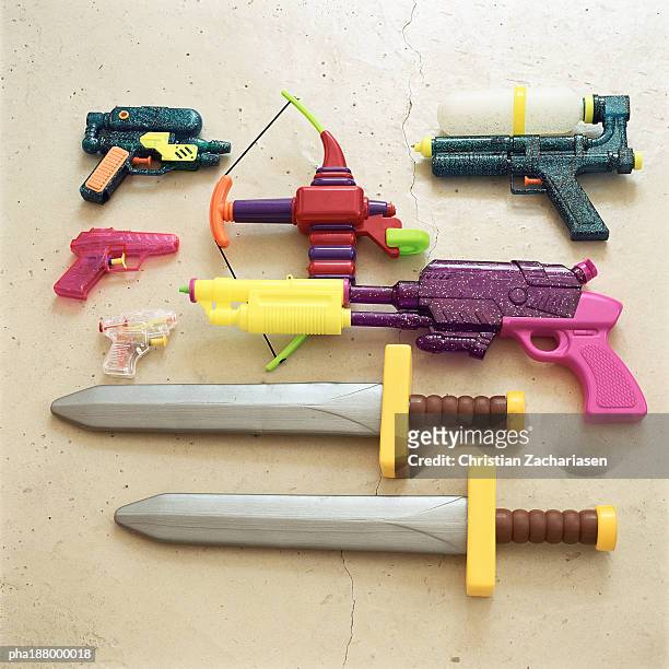 children's toy swords and guns. - spada foto e immagini stock