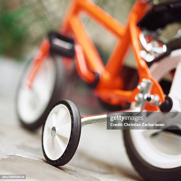 child's bike with training wheels, close up. - training wheels stock pictures, royalty-free photos & images