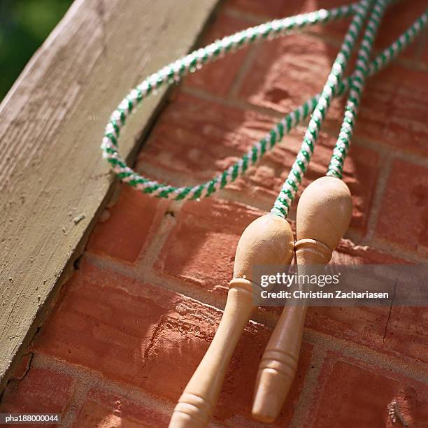 jump rope hanging on brick wall. - wall hanging stock pictures, royalty-free photos & images