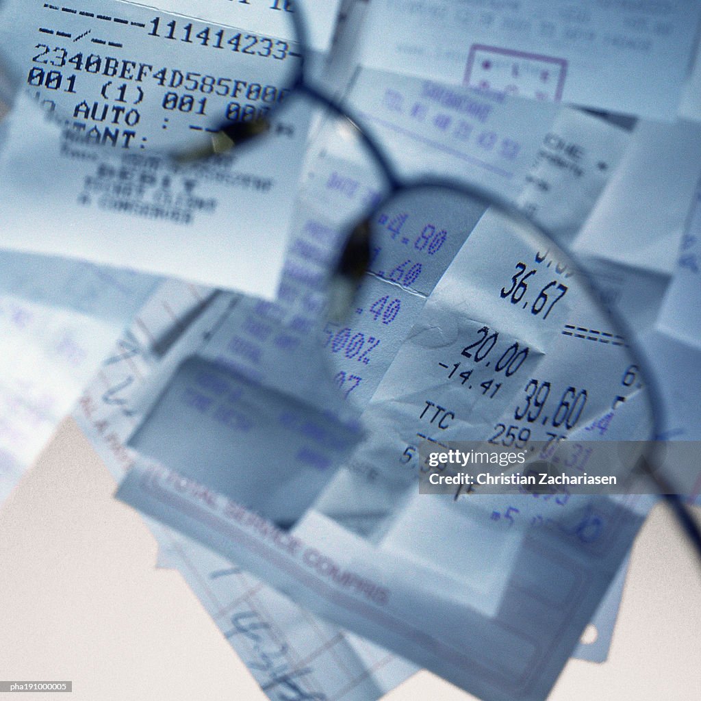 Sales receipts viewed through glasses.