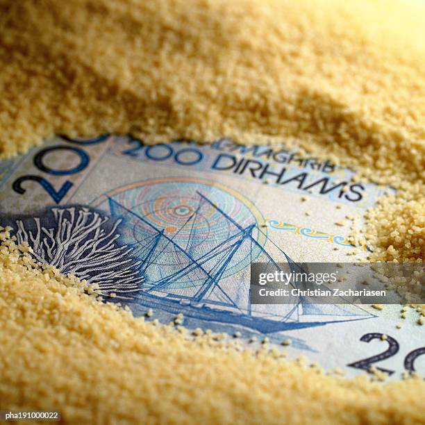 paper money covered with sand. - dirham stock pictures, royalty-free photos & images