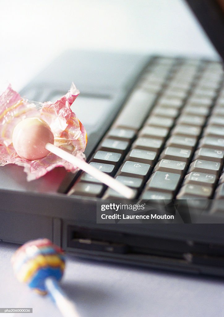 Two lollipops and one laptop.