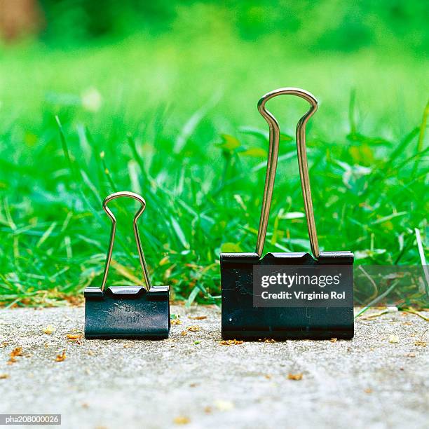 binder clips on a path. - binder clip stock pictures, royalty-free photos & images