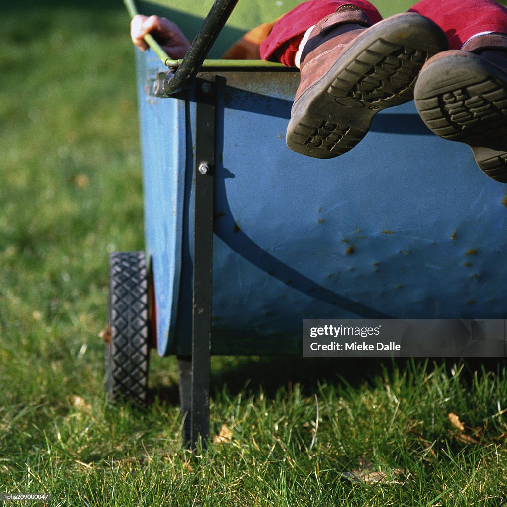 Feet sticking out of a cart.