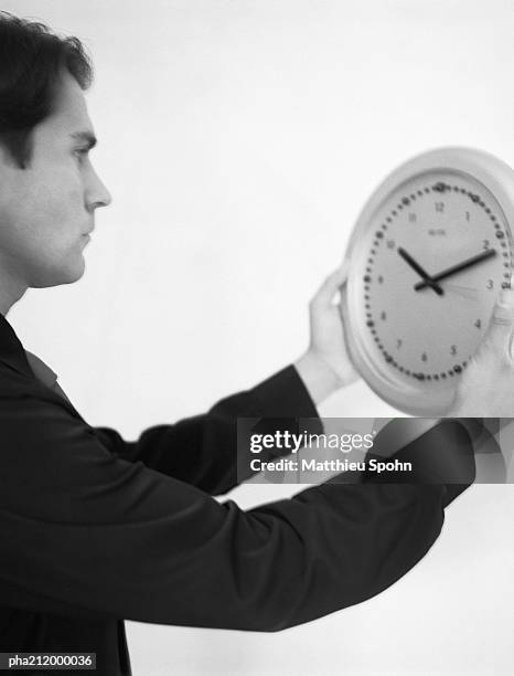 man holding a clock, b&w. - bronwen smith of b floral and the today shows lilliana vazquez host a private floral accessories event in nyc stockfoto's en -beelden