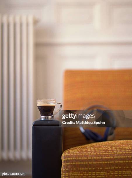 chair with headphones and cup placed on it. - armrest stock pictures, royalty-free photos & images