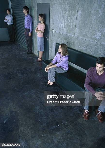 two people sitting on bench, three people standing, all spaced apart from one another. - aother stock pictures, royalty-free photos & images