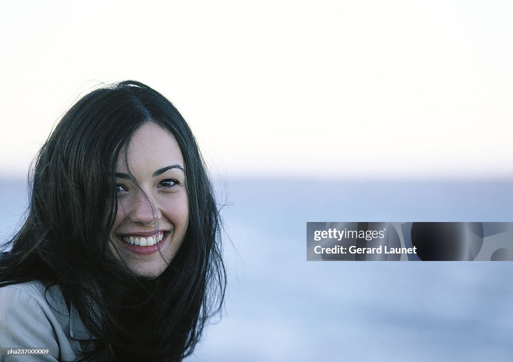 Young woman smiling, close-up.