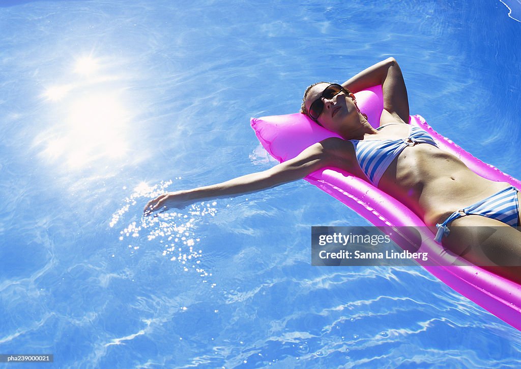 Woman lying on air mattress, elevated view