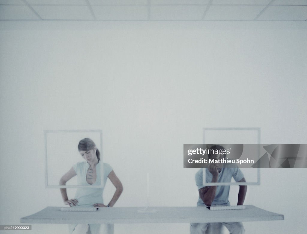 Man and woman sitting at desk